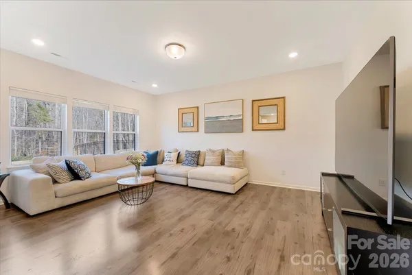 a living room with furniture wooden floor and a flat screen tv