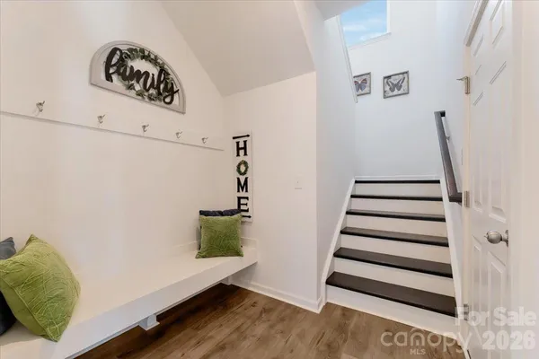 a view of entryway with stairs and wooden floor