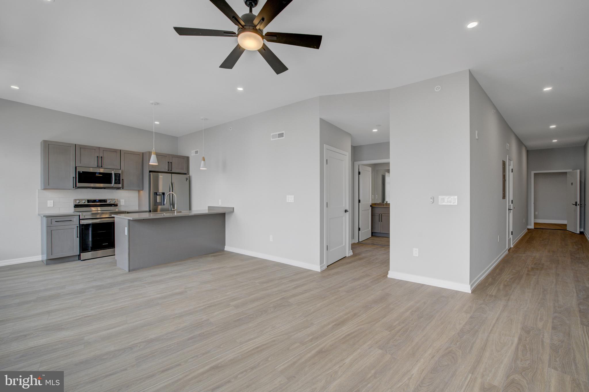 2445 Innovator Way, Unit 3A Philadelphia, PA 19146 - Photo 1 of 17 a view of a kitchen with a sink and dishwasher a refrigerator with wooden floor