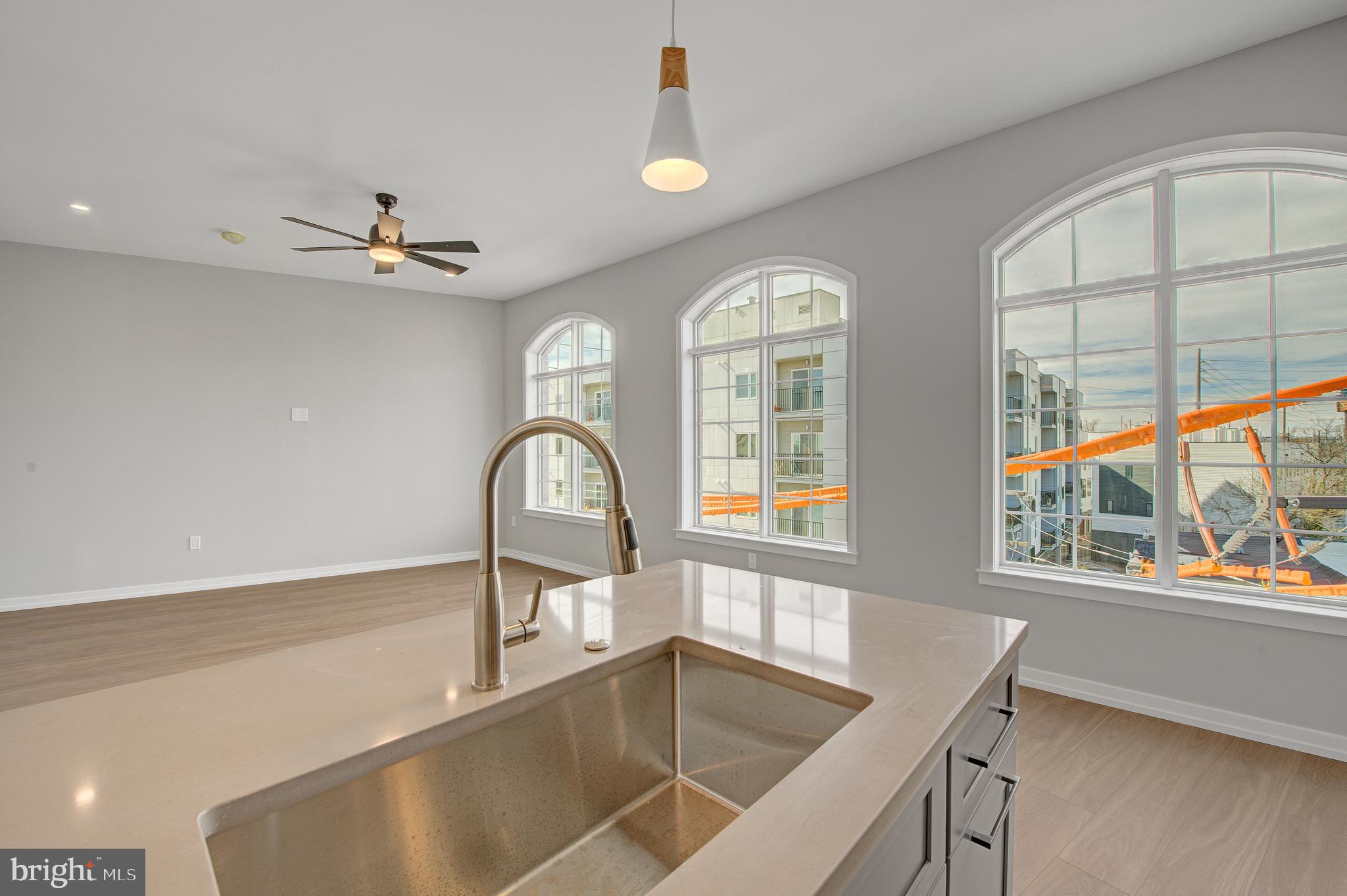 2445 Innovator Way, Unit 3A Philadelphia, PA 19146 - Photo 12 of 17 a view of a kitchen counter space with a sink and living room