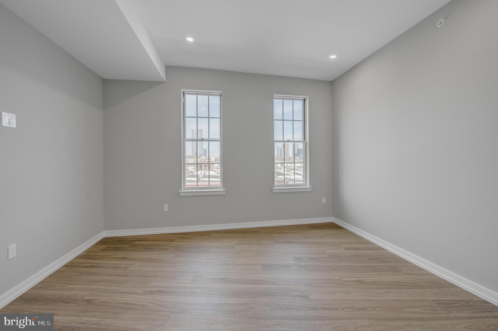 2445 Innovator Way, Unit 3A Philadelphia, PA 19146 - Photo 3 of 17 wooden floor in an empty room with a window