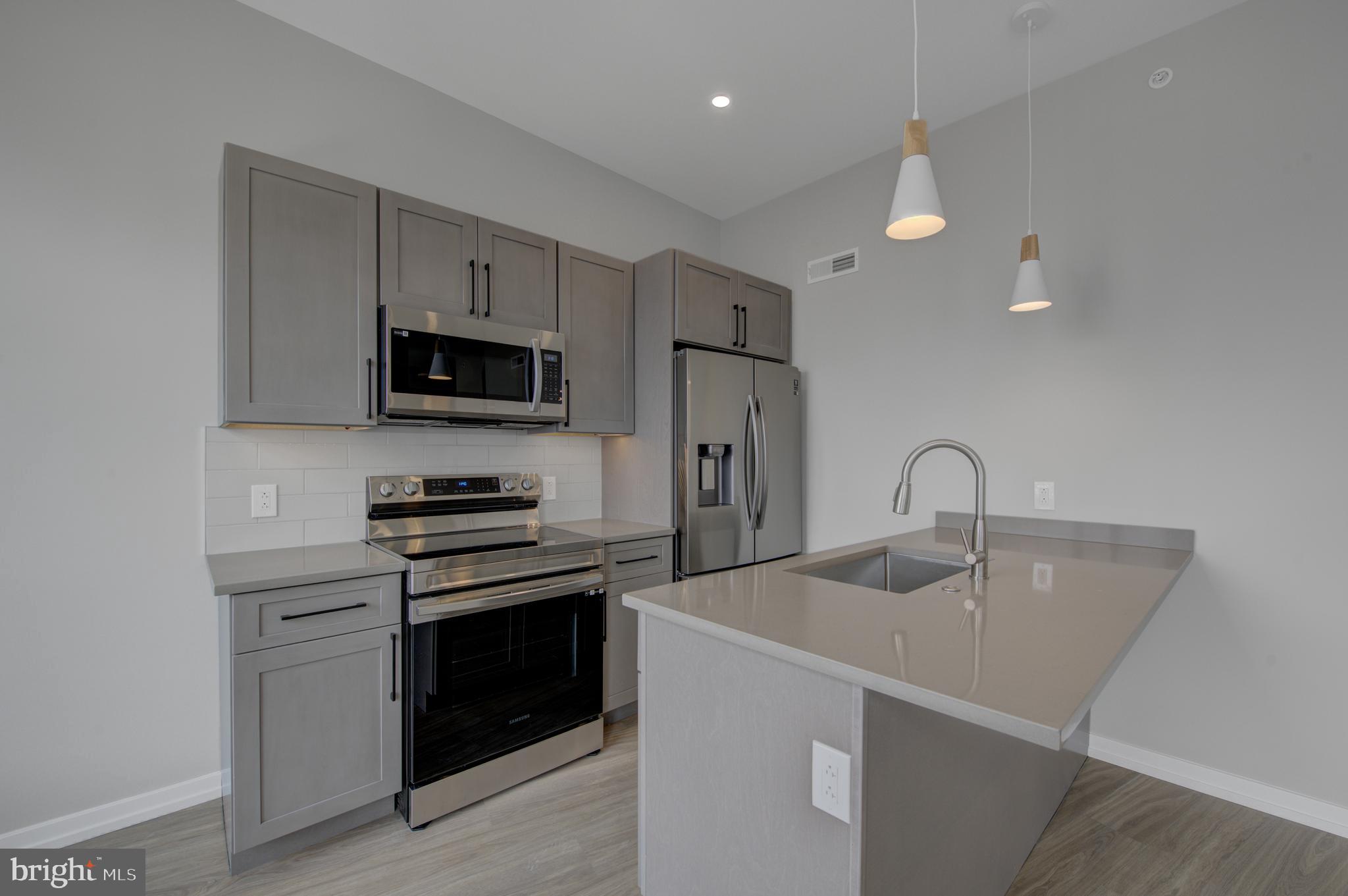 2445 Innovator Way, Unit 3A Philadelphia, PA 19146 - Photo 5 of 17 a kitchen that has a sink and a stove top oven