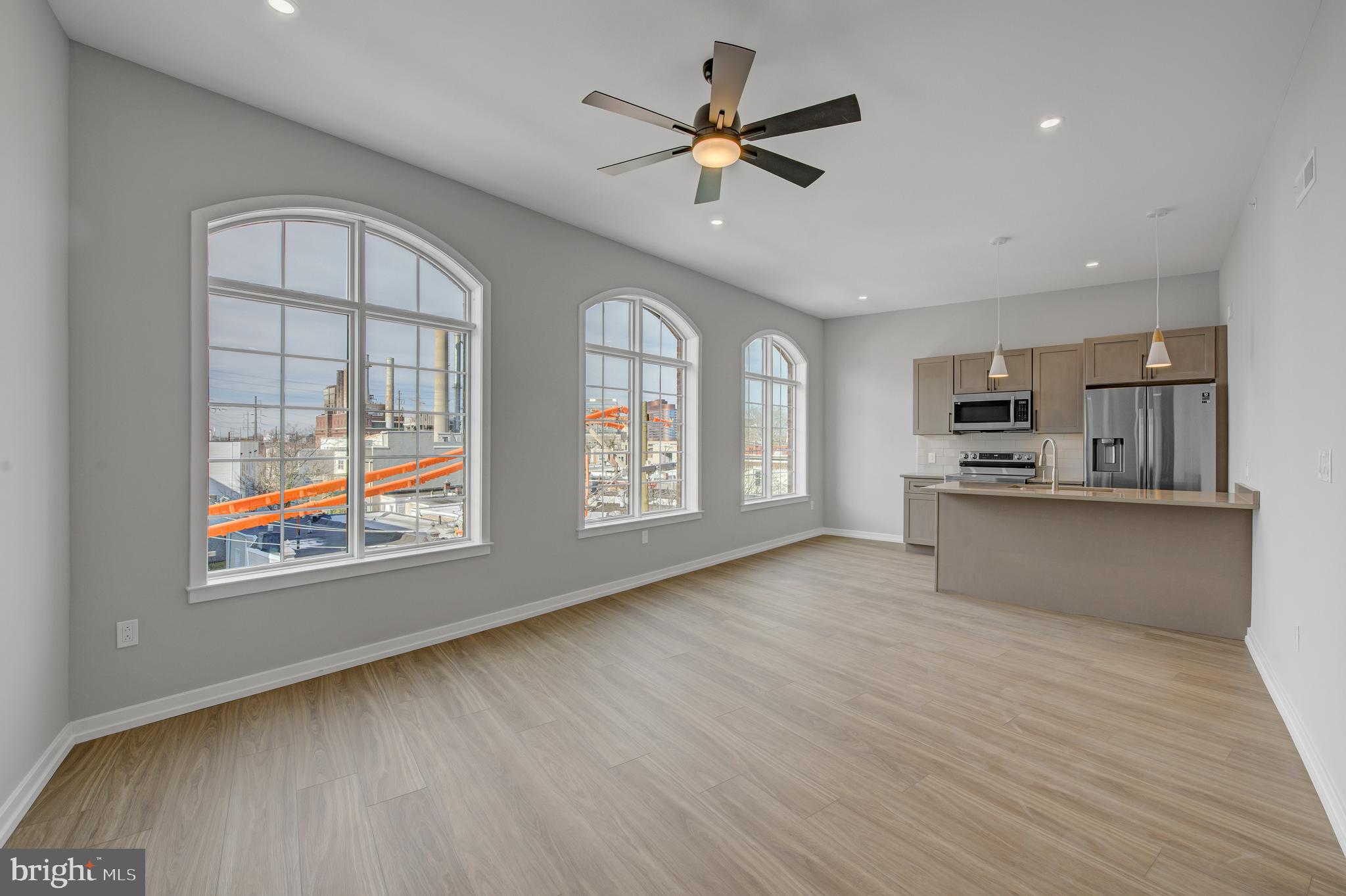 2445 Innovator Way, Unit 3A Philadelphia, PA 19146 - Photo 9 of 17 a view of an empty room with a kitchen and windows