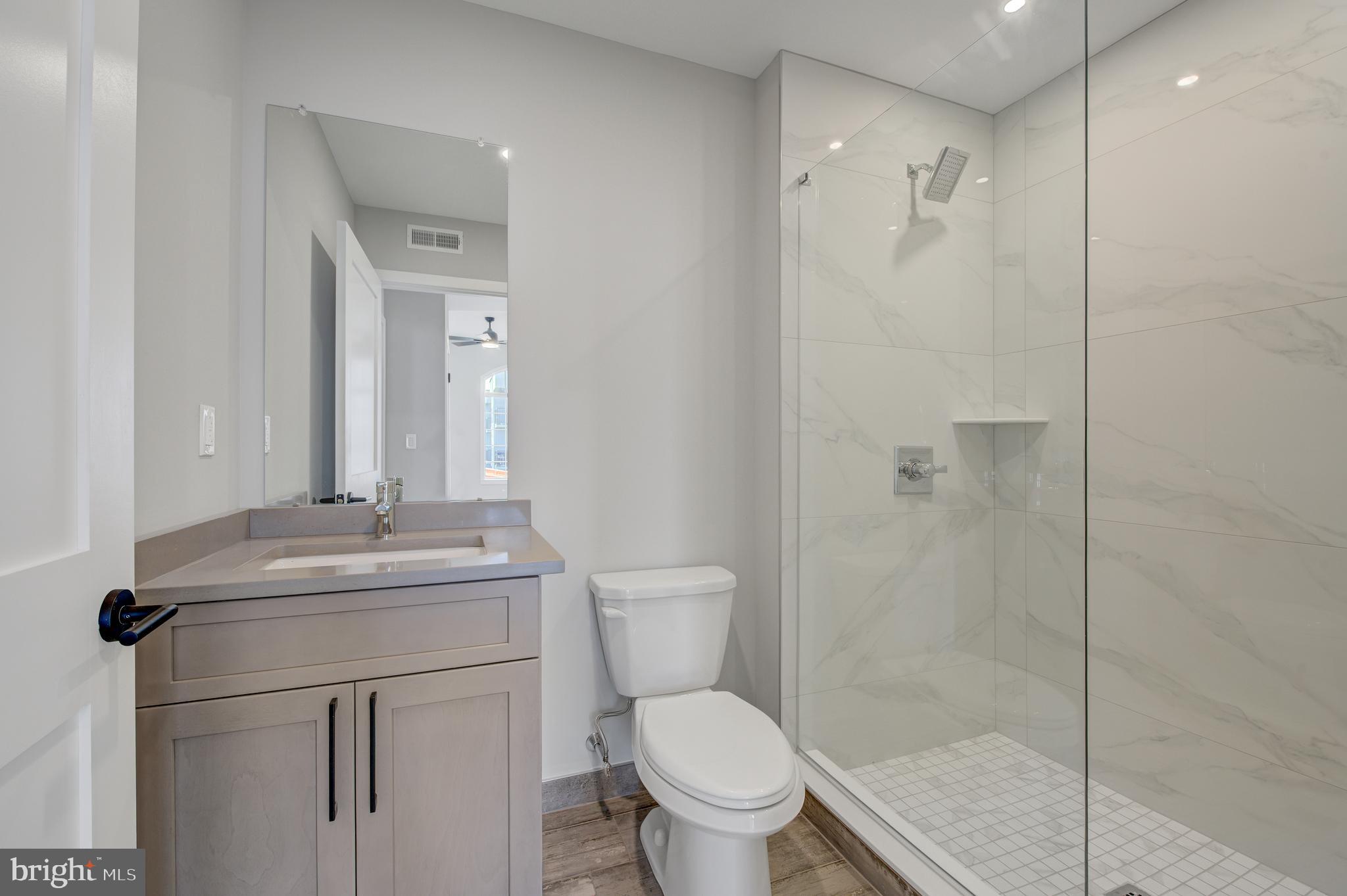 2445 Innovator Way, Unit 3A Philadelphia, PA 19146 - Photo 10 of 17 a bathroom with a granite countertop sink toilet and shower