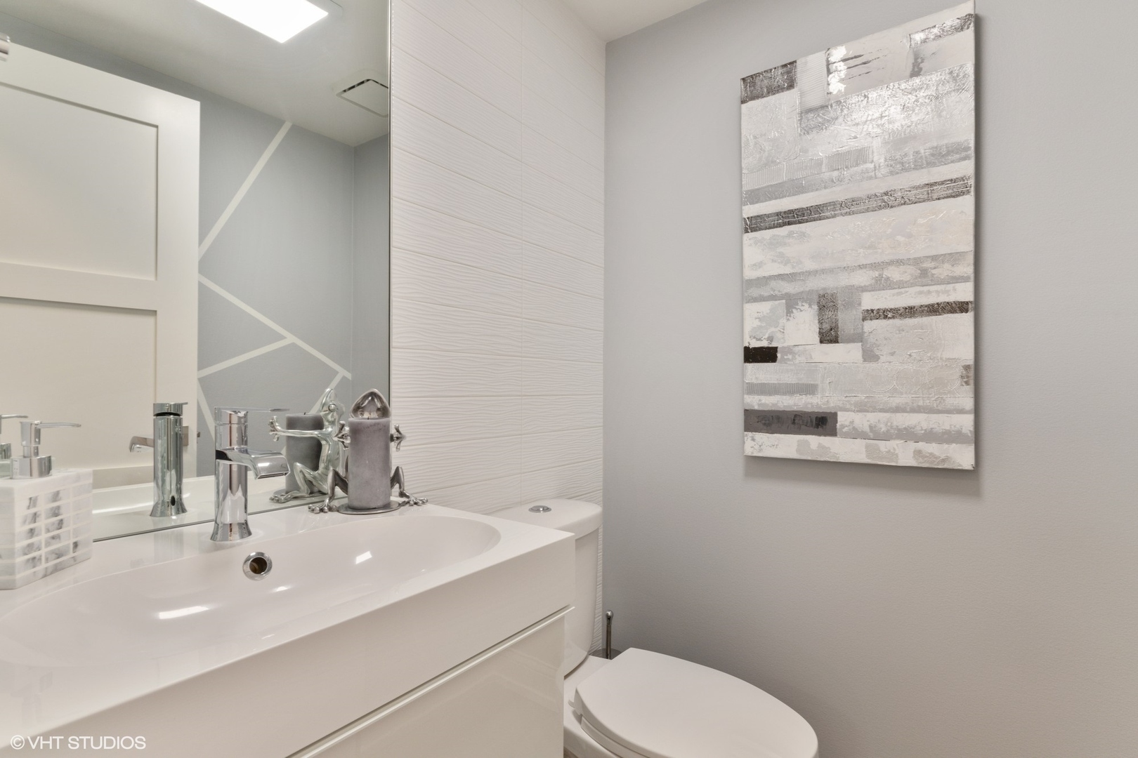1430 Waukegan Road Deerfield, IL 60015 - Photo 17 of 20 a bathroom with a sink a toilet and mirror