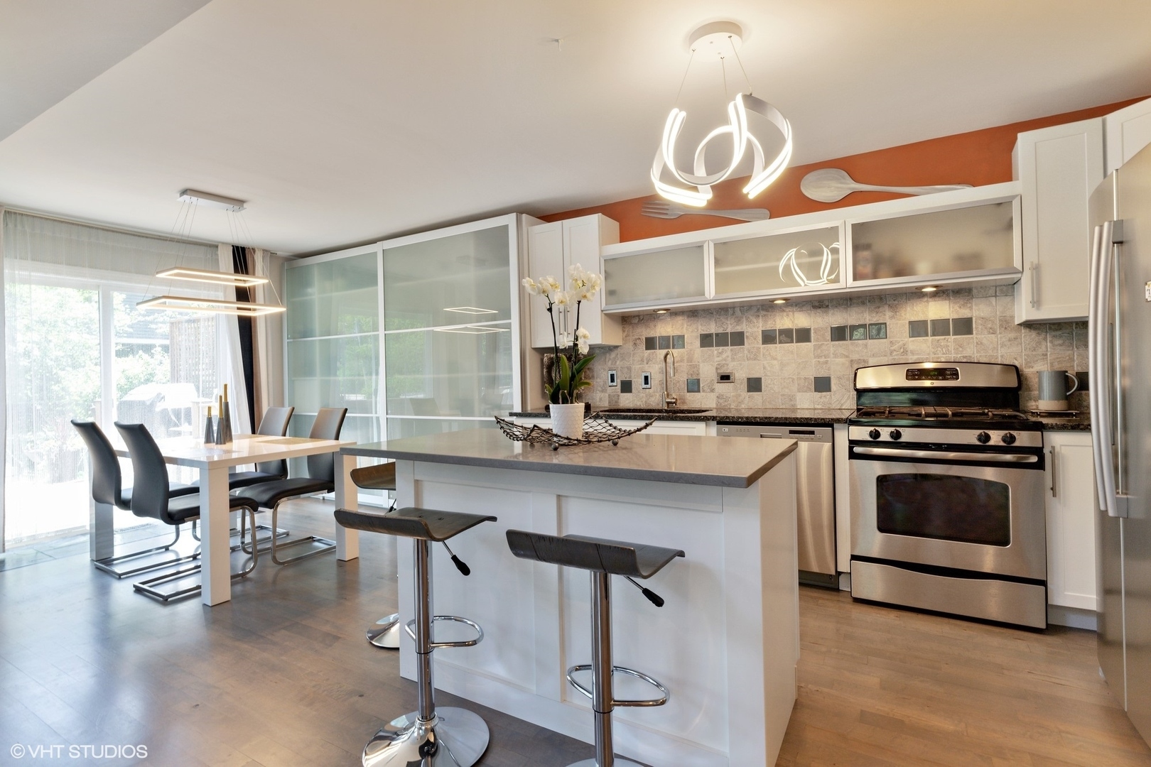 1430 Waukegan Road Deerfield, IL 60015 - Photo 5 of 20 a kitchen with stainless steel appliances a stove a sink a dining table and chairs