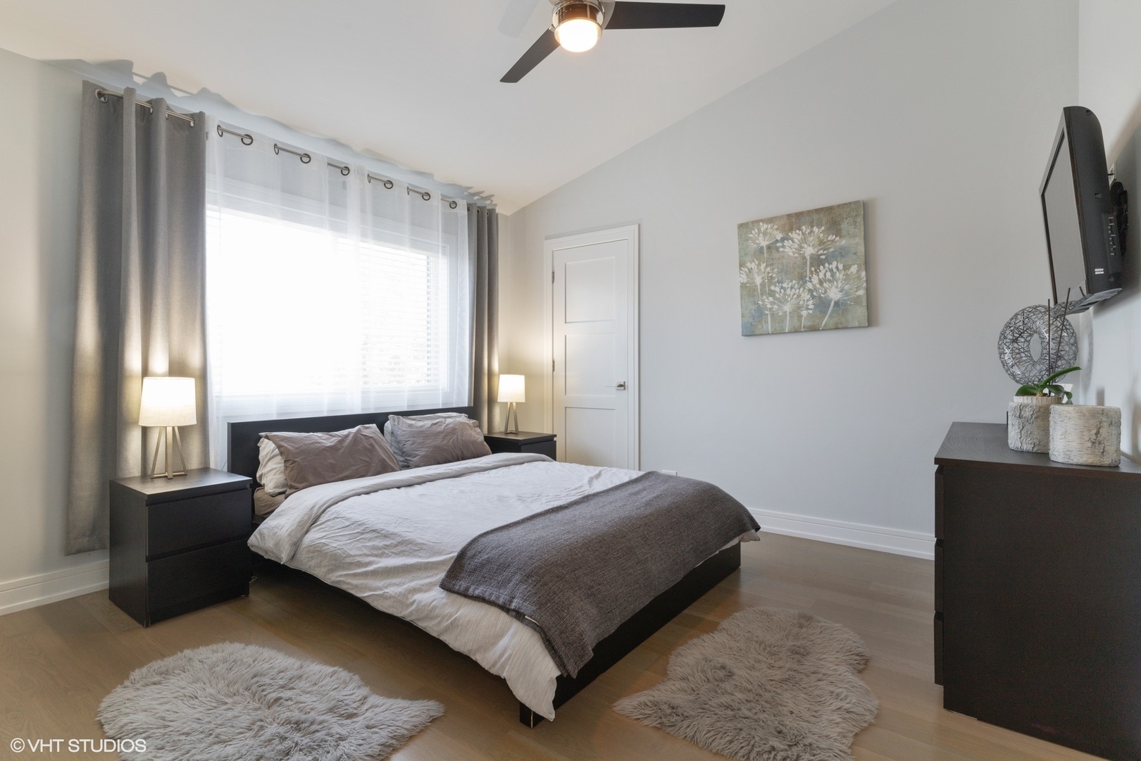 1430 Waukegan Road Deerfield, IL 60015 - Photo 8 of 20 a bedroom with a bed lamp and a large window