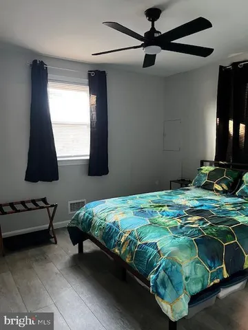 a bedroom with a bed and a flat tv screen on the dresser