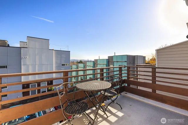 a balcony with a table and chairs