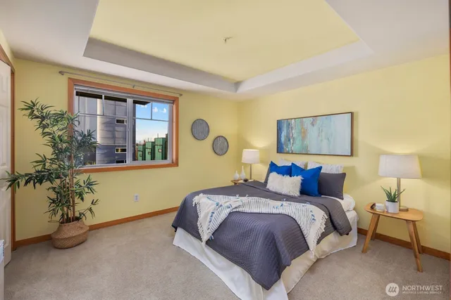 a bedroom with a bed and a painting on the wall