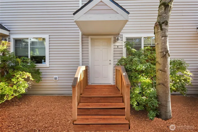a view of a house with potted plants