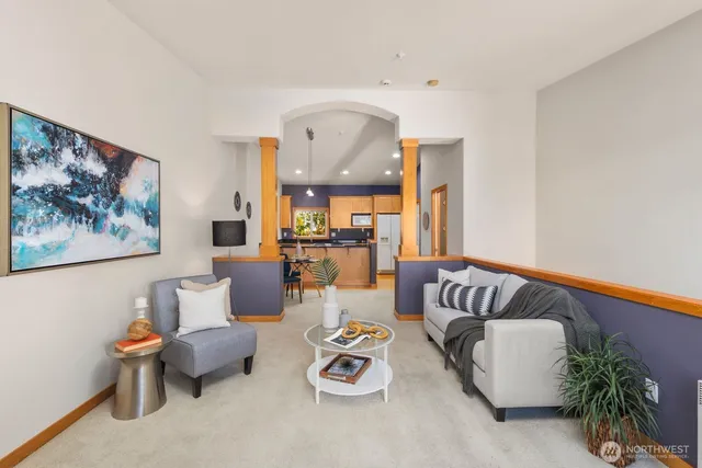 a living room with furniture and a potted plant