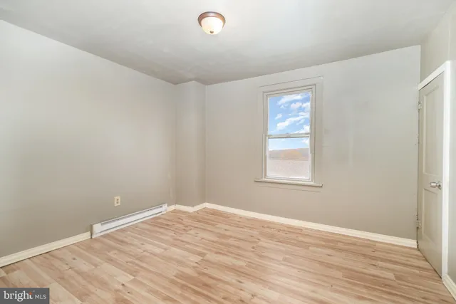 a view of a room with wooden floor and windows