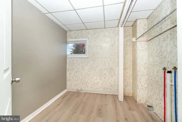 a view of a hallway with wooden floor and closet
