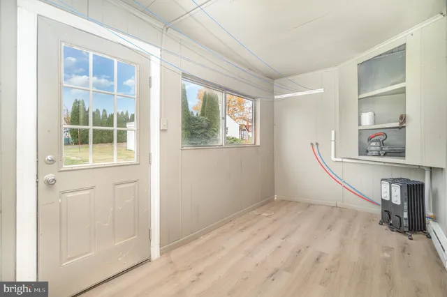 a view of a room with wooden floor and windows