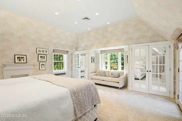 a living room with furniture a flat screen tv and a large window