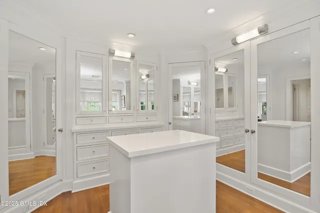 a view of walk in closet and bedroom