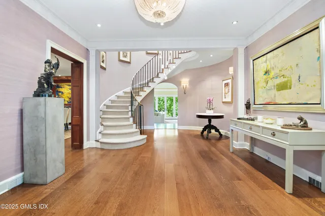 a view of a living room and dining room with wooden floor