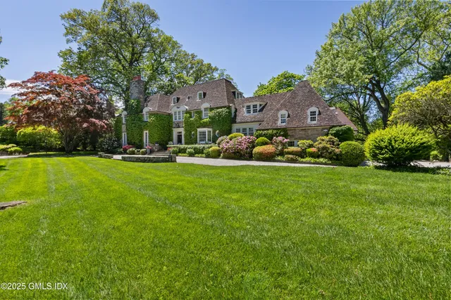 an aerial view of a house with yard swimming pool and outdoor seating