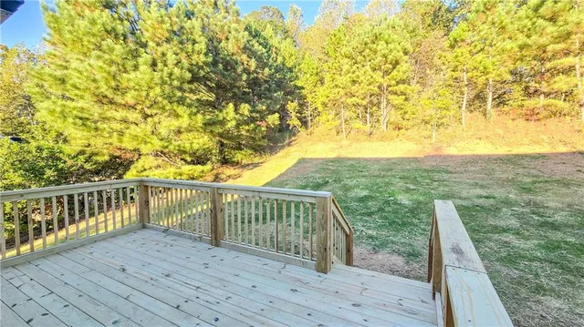 a view of balcony with wooden floor and fence