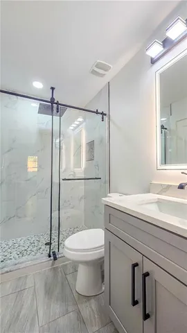 a bathroom with a sink toilet and shower