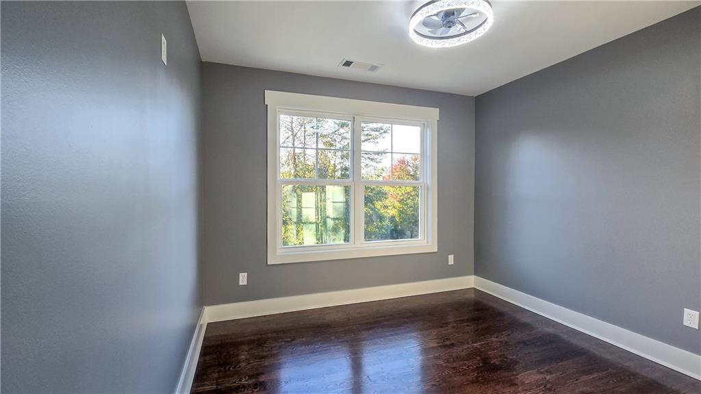 49 Sweetgum Street Talmo, GA 30575 - Photo 16 of 36 an empty room with wooden floor and windows