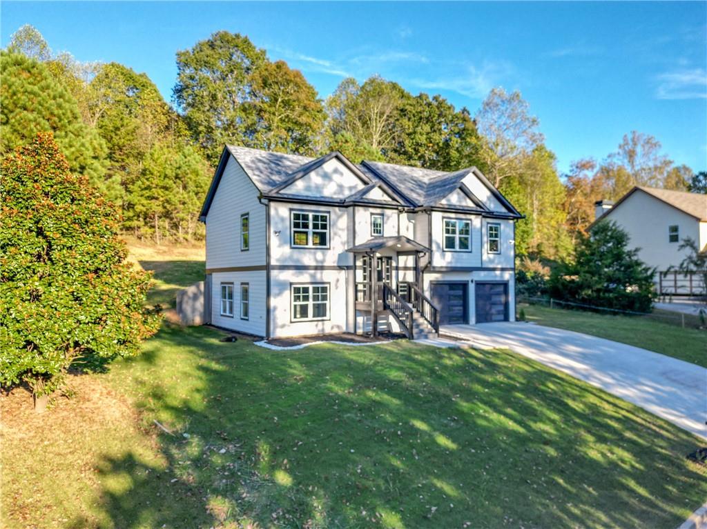 49 Sweetgum Street Talmo, GA 30575 - Photo 2 of 36 a view of a house with a big yard and large tree
