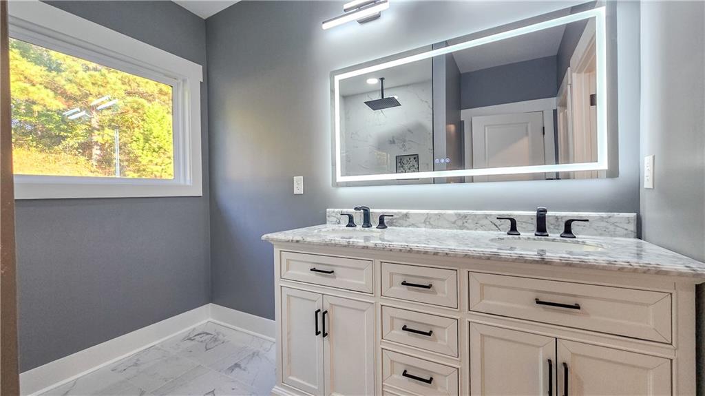 49 Sweetgum Street Talmo, GA 30575 - Photo 21 of 36 a bathroom with a granite countertop sink and mirror