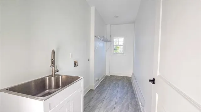 a kitchen with a sink and chandelier