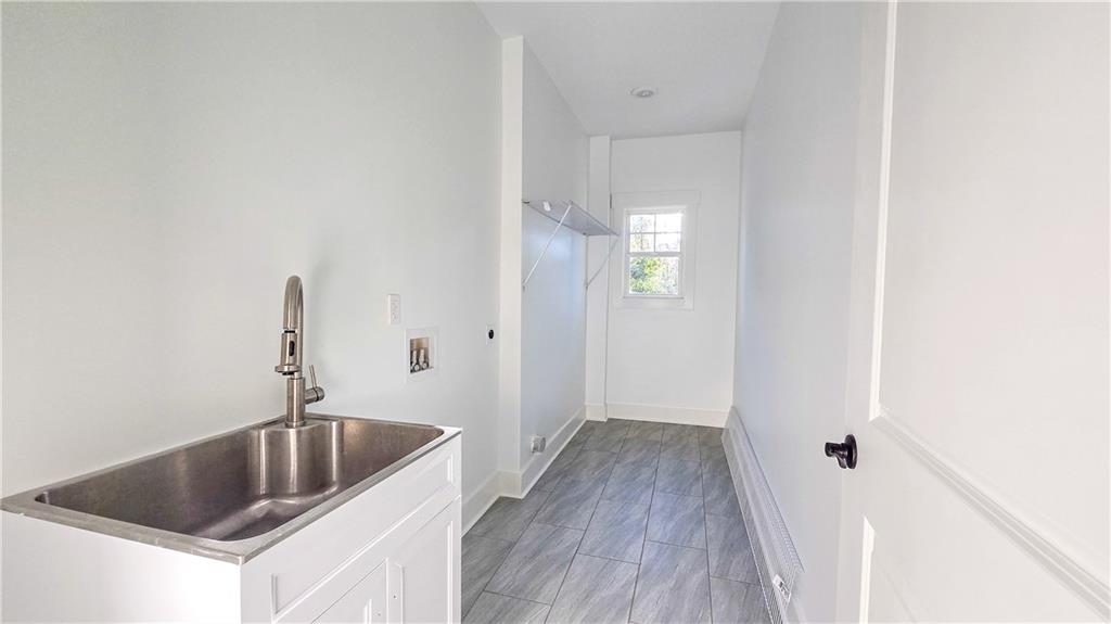 49 Sweetgum Street Talmo, GA 30575 - Photo 31 of 36 a kitchen with a sink and chandelier