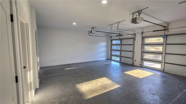 an empty room with windows and ceiling fan
