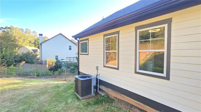 a view of a house with backyard and porch
