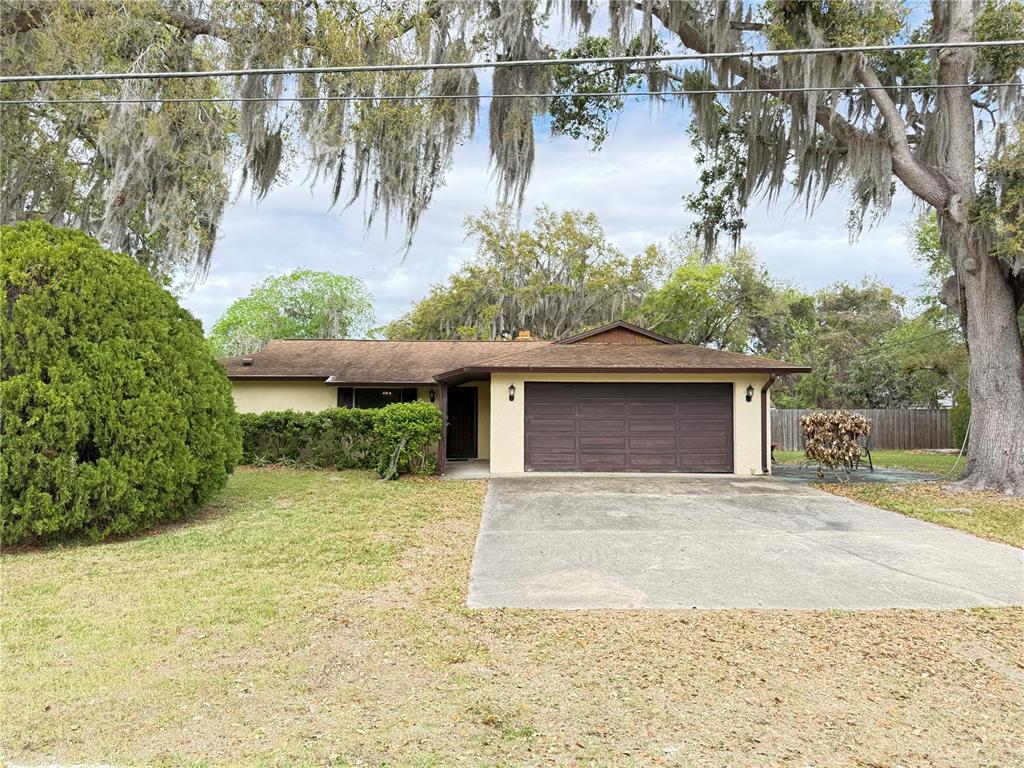 2331 Juniper Drive Edgewater, FL 32141 - Photo 1 of 1 a front view of a house with a yard and garage