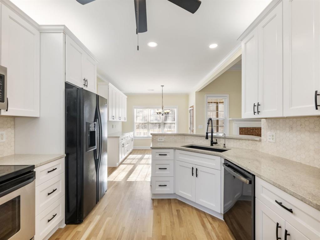 799 Gold Crest Road Braselton, GA 30517 - Photo 14 of 71 a kitchen with stainless steel appliances granite countertop a sink stove and refrigerator