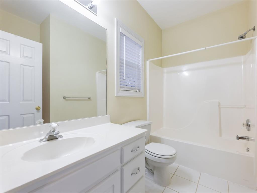 799 Gold Crest Road Braselton, GA 30517 - Photo 22 of 71 a bathroom with a granite countertop sink toilet a large mirror a bathtub and shower