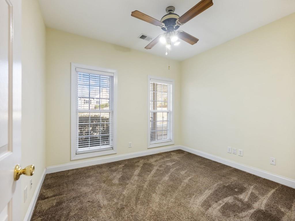 799 Gold Crest Road Braselton, GA 30517 - Photo 26 of 71 an empty room with windows and fan