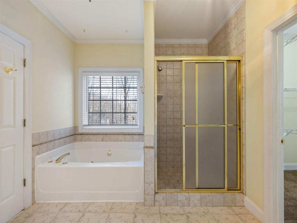799 Gold Crest Road Braselton, GA 30517 - Photo 33 of 71 a bathroom with a bathtub and a shower