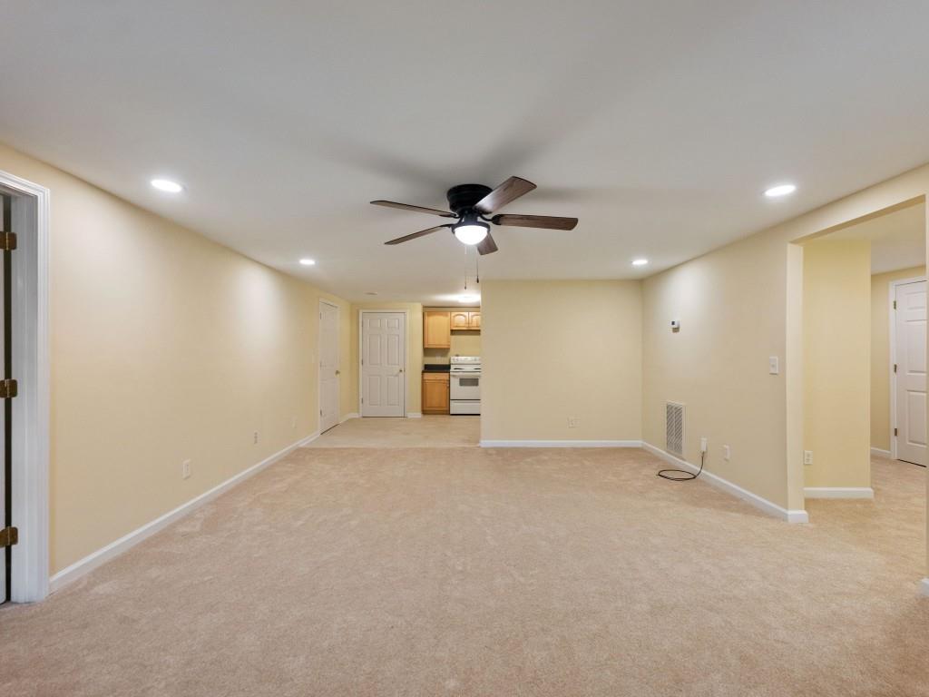 799 Gold Crest Road Braselton, GA 30517 - Photo 44 of 71 an empty room with a ceiling fan and windows