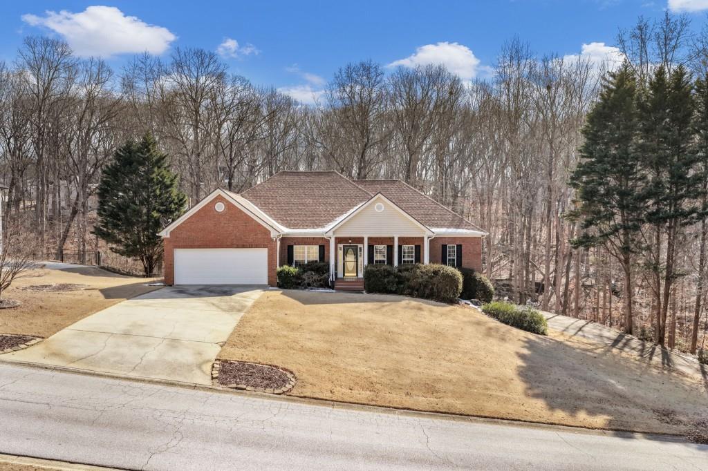 799 Gold Crest Road Braselton, GA 30517 - Photo 53 of 71 a front view of a house with a yard covered in snow
