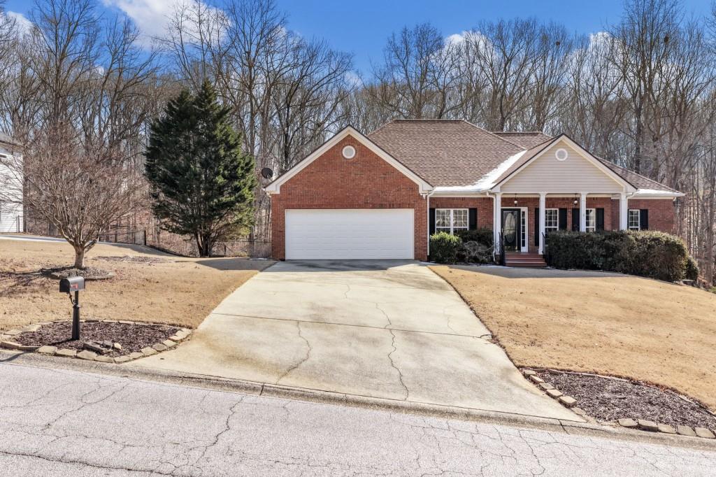 799 Gold Crest Road Braselton, GA 30517 - Photo 59 of 71 a front view of a house with a yard and trees