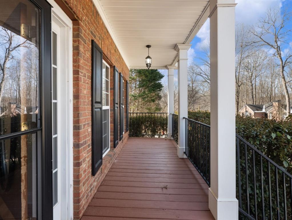 799 Gold Crest Road Braselton, GA 30517 - Photo 60 of 71 a view of a balcony with wooden floor and stairs