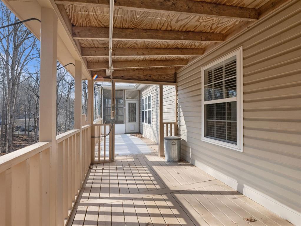 799 Gold Crest Road Braselton, GA 30517 - Photo 64 of 71 a view of a porch with wooden floor and windows