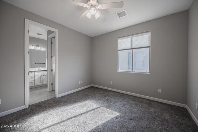 wooden floor in an empty room with a bathroom