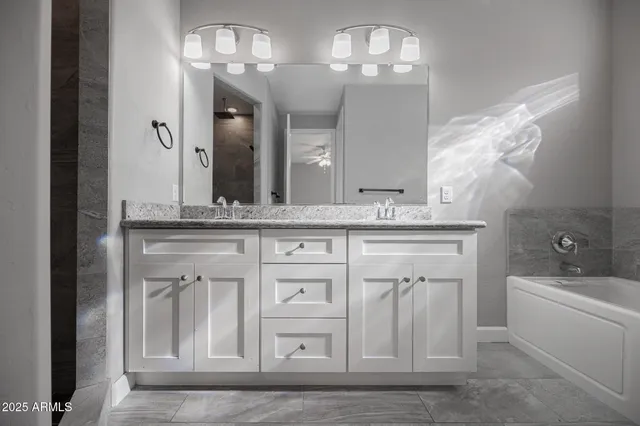 a bathroom with a double vanity sink and a mirror