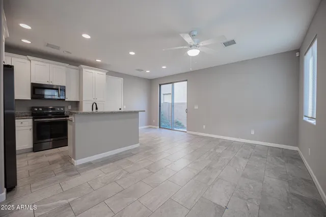 a view of kitchen with cabinets and microwave
