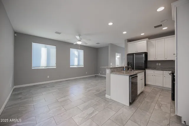 a kitchen with a stove a sink and a refrigerator