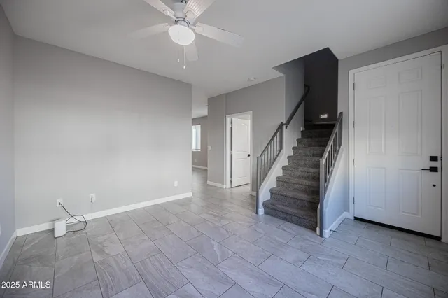 a view of entryway and hall with a ceiling fan