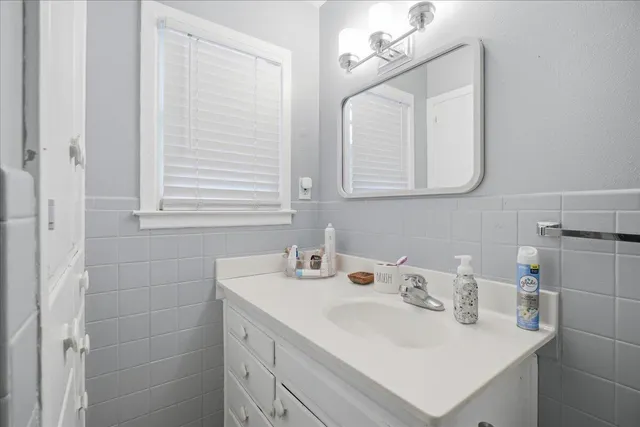 a bathroom with a sink vanity and a mirror