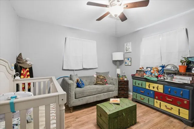 a living room with furniture and a book shelf