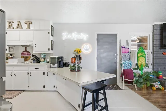 a kitchen with stainless steel appliances cabinets and a potted plant